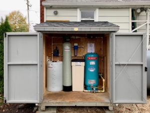 A Solution Feeder, water softener, a sediment filter and a pressure tank in a shed