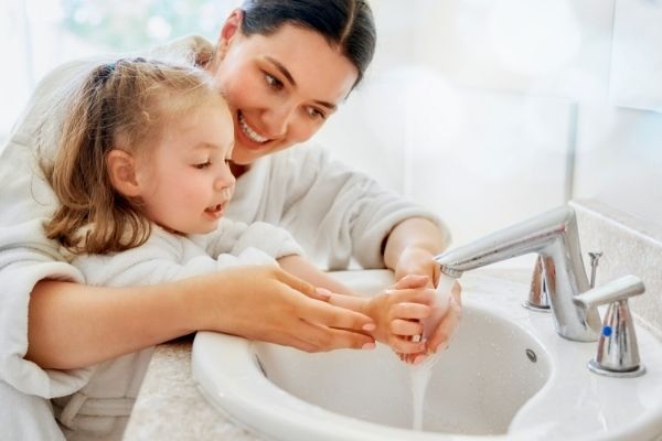 new well pump replacement in maryland one woman and one child washing hands