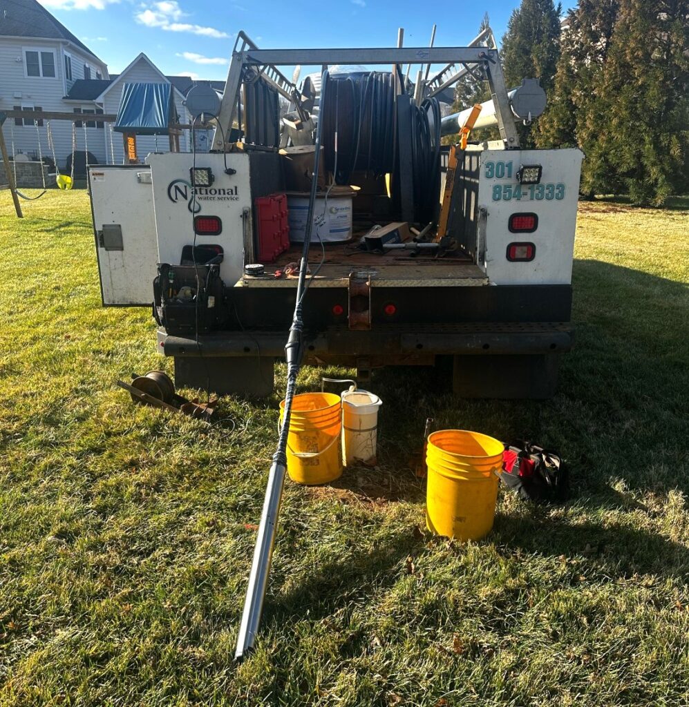 A White Truck With A Hose In The Back