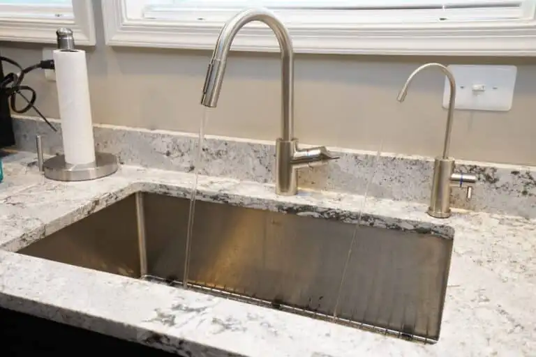 A Sink With A Faucet Running From It