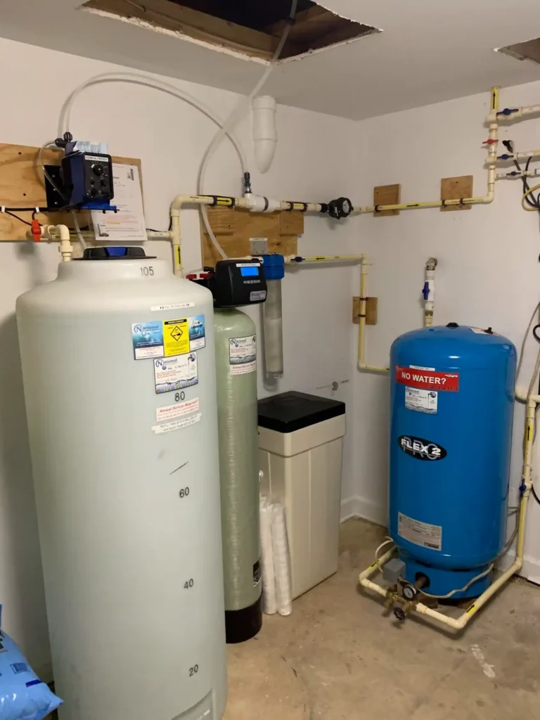 A Room With Several Large Tanks And Pipes