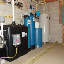 Radon in Water Remediation System to remove cancer causing radon from water with a water pressure booster pump, flood prevention isolation boards, raised Hot Water Heater and a Water Softener for hard water and an Acid Neutralizer for pH & corrosion control