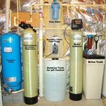 Whole House Water Treatment System. A Well Water Pressure Tank, Twin Carbon Tanks for smells, odors, low levels of radon and more,a Solution Feeder for pH & corrosion control,a Water Softener with Brine Tank for hard water & a Sediment Filter.