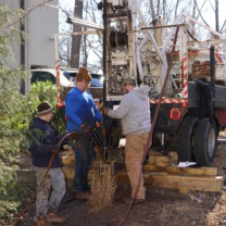 hoist truck pulling up Hard Pipe to reach a Broken Well Water Pump