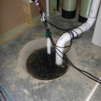 Sump pump lowered into concrete basement floor without a clear cover