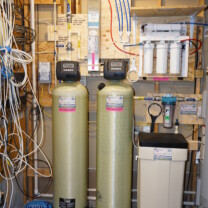 an acid neutralizer, a water softener, a sediment filter, a constant pressure system, an ultraviolet light and a reverse osmosis