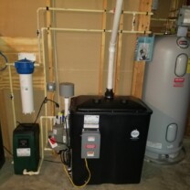 radon remediation system with a pressure booster, a sediment filter and a water heater