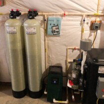 twin carbon tanks and a radon remediation system with a pressure booster