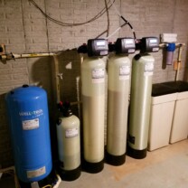 a pressure tank, a nitrate removal tank, a water softener, an acid neutralizer and a sediment filter