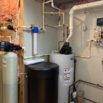 A water softener with a commercial brine tank, Solution feeder, a KX Pro, a sediment filter, a water heater and a constant water pressure system