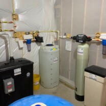 Radon removal system with a pressure booster, a sediment filter, Solution feeder and a water softener