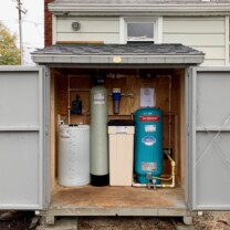 A Solution Feeder, water softener, a sediment filter and a pressure tank in a shed